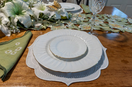 White lilies on an Easter table dÃ©cor setting with fine China and silverware.の写真素材