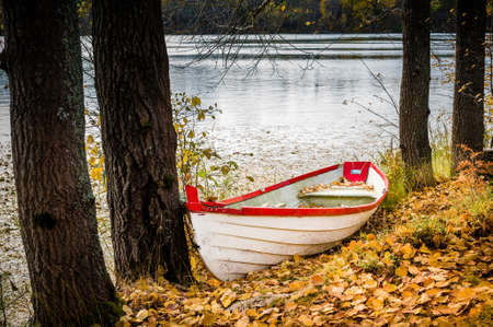 Old boat at colorful autumn park in Imatra, Finland