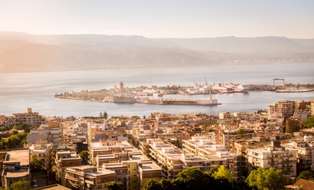 Messina city, harbour and channel view in warm light just before sunsetの写真素材