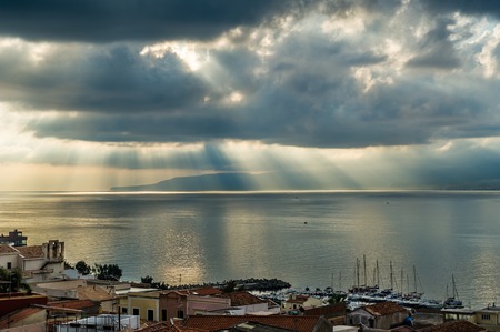 Rays of the sun is passing through the dark clouds seascapeの写真素材