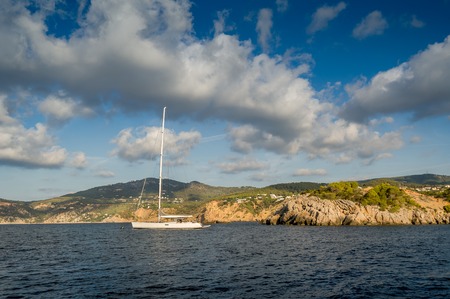 Sailing yachts stays at anchor in Mediterranean sea bay. Balearic islands, Spainの写真素材