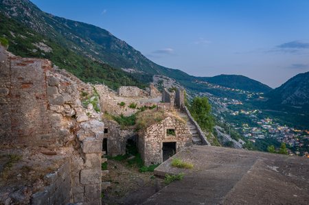 Ancient monastery ruins in the mountains above the Kotor historical town. Popular touristic pedestrian step way to mountain. Late evening lightning. Montenegro.の写真素材