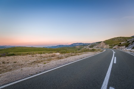 Calm evening warm light at perfect highway to Durmitor national park and Zabljak resort town. Montenegro.の写真素材