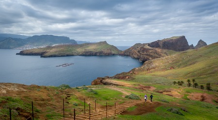 Tourists couple doing their hike at the beautiful landscape od Madeira island east coast. Casa do Sardinha, Madeira, Portugal.の写真素材