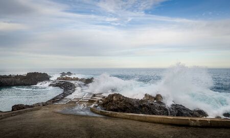 Waves splashing of pier to the Atlantic ocean in Seixal. North coast of Madeira island, Portugal.の写真素材
