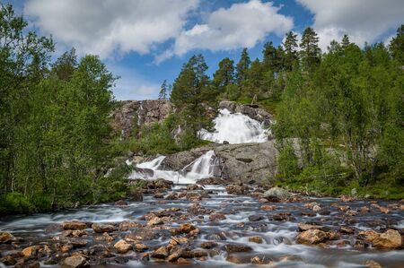 Long exposure landscape view of waterfall on the rocks and fast mountain river. Norway country.の写真素材