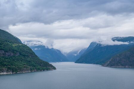 Typical North sea fjord landscape at cloudy summer day. Eidfjord, Hordaland, Norway.の写真素材