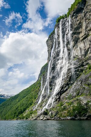 Geiranger fjord famous waterfalls, accessible only from water, vertical photo. Popular kayak trip destination. Geirangerfjord, Norway.の写真素材