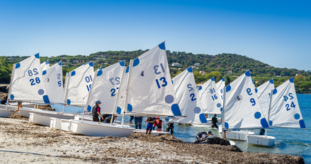 Optimist sailing boats at the beach of Saint-Tropez. Provence Cote d'Azur, France.の写真素材