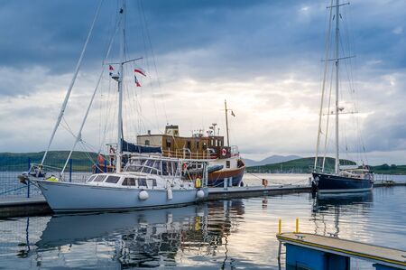 Sailing vessels at late evening light. Oban marina, Scotland.の写真素材