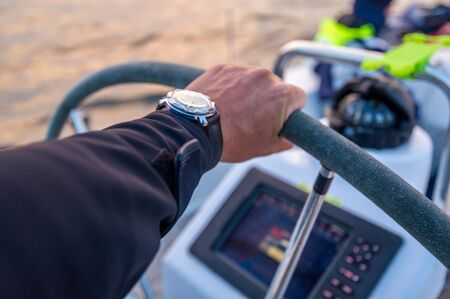 Skippers arm at the helm
