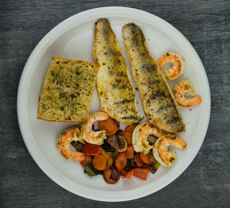 freshwater pike-perch fillet with garlic herbs and spicesの写真素材