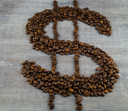 fair trade coffee price - roasted coffee beans and moneyの写真素材