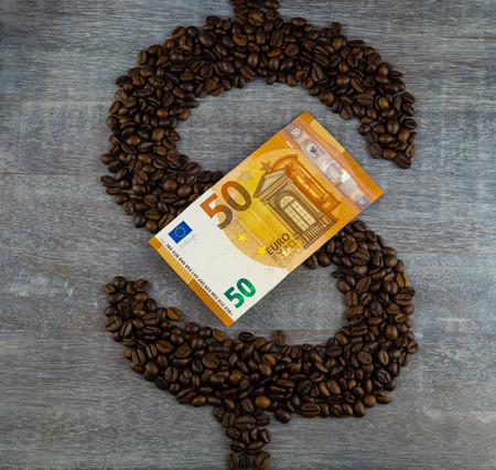 fair trade coffee price - roasted coffee beans and moneyの写真素材