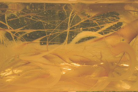Abstract art with emulsion of oil paint in waterの写真素材