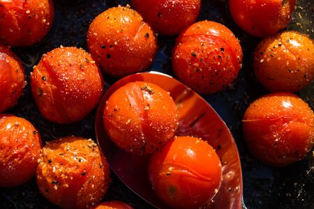 Roasted cherry tomatoes with olive oil salt and pepperの写真素材