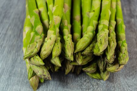 Uncooked Fresh green german asparagusの写真素材