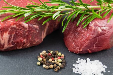 Raw filet steak with spices and vegetablesの写真素材