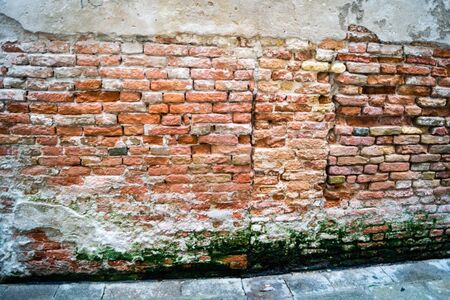 Wall of bricks or stones and fuguesの写真素材