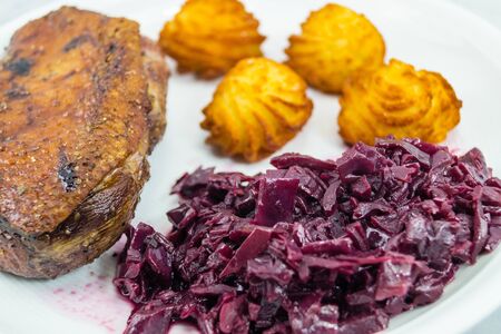 Fried duck breast with red cabbage and croquettesの写真素材