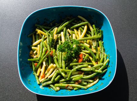 Fresh green beans with tomato and parsley