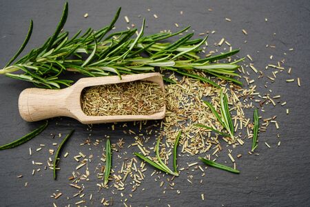 Rosemary Salvia rosmarinus and a wooden spoon