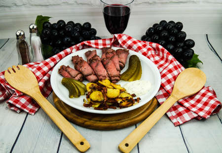 Roast beef with fried potatoes and tartar sauceの写真素材