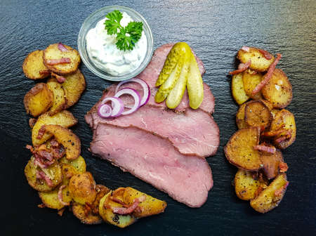 Roast beef with fried potatoes and tartar sauceの写真素材