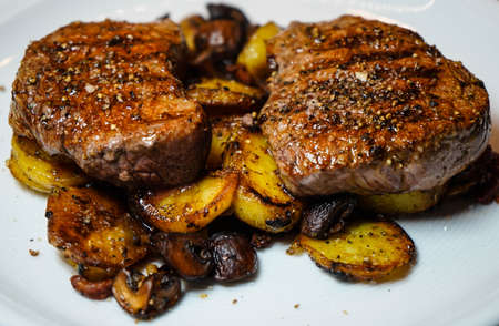 fried fillet steak with potatoes and mushroomsの写真素材