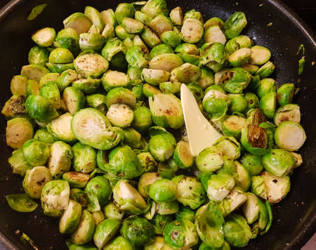 halved Brussels sprouts in a panの写真素材