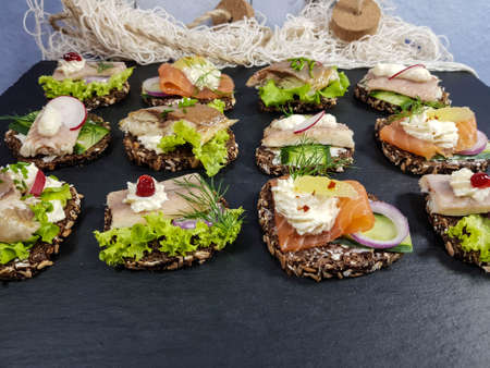 Canapes with smoked fish and saladの写真素材