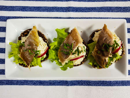 Canapes with smoked fish and salad
