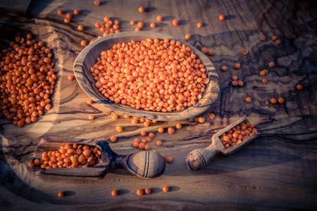 red lentils on olive woodの写真素材