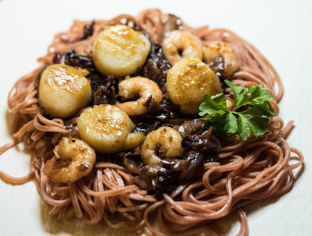 scallops with red linguine pasta herbs and spicesの写真素材