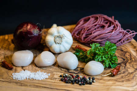 scallops with red linguine pasta herbs and spicesの写真素材