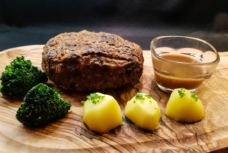 Traditional German meatloaf with potatoes and broccoliの写真素材