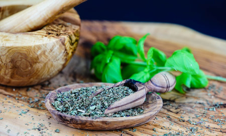 Fresh and rubbed basil on olive woodの写真素材