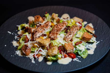 traditional caesars salad with grilled chicken Bacon Stripes and salted garlic bread