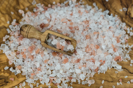 Himalayan rock salt on olive woodの写真素材