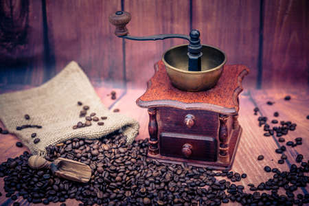 roasted coffee beans and a vitage coffee grinderの写真素材