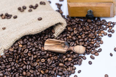 roasted coffee beans and a vitage coffee grinder