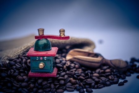 roasted coffee beans and a vitage coffee grinder