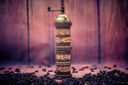 roasted coffee beans and a vitage coffee grinderの写真素材