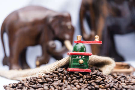 roasted coffee beans and a vitage coffee grinderの写真素材