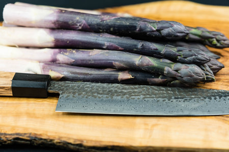 purple Asparagus officinalis a seasonal vegetable on olive woodの写真素材