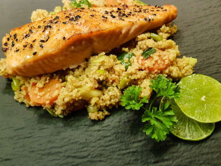Norwegian fjord salmon with black sesame seeds on couscousの写真素材