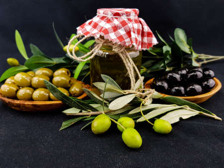 cold pressed olive oil with branch and fruitsの写真素材