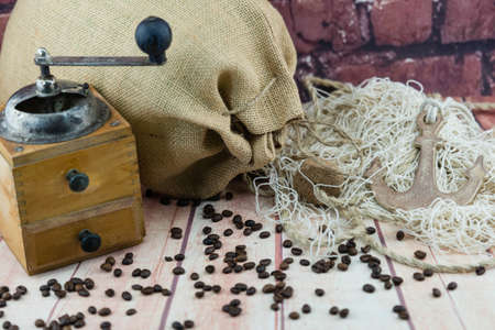 roasted coffee beans and a vitage coffee grinderの写真素材