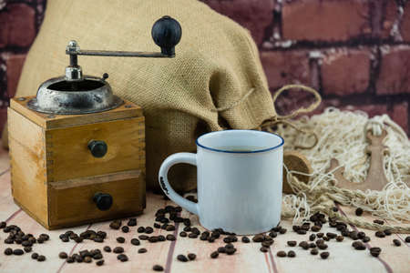 roasted coffee beans and a vitage coffee grinderの写真素材