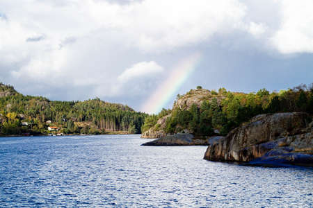 With a cruise ship in the fjords of norwayの写真素材